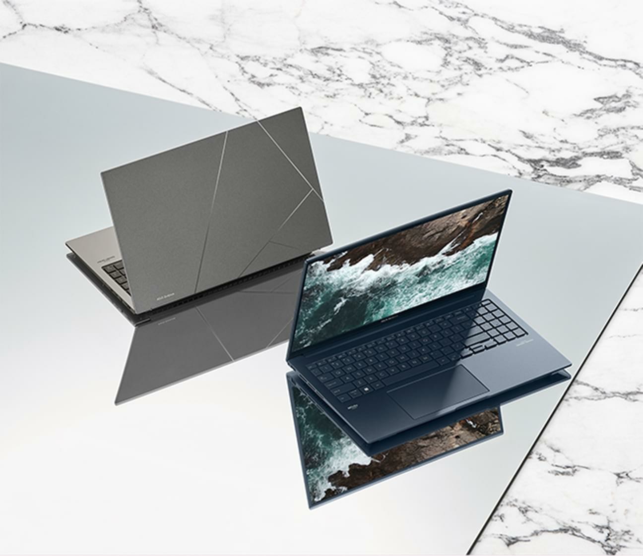 Hai chiếc Zenbook 15 OLED được đặt trên một chiếc gương phản chiếu. Một chiếc màu Xanh lam trầm hiển thị hình ảnh đại dương trên màn hình. Chiếc màu Xám Đá Bazan hiển thị hình ảnh chữ A lồng tinh tế trên nắp.